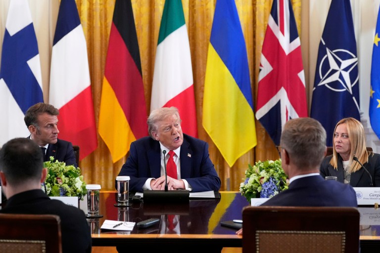 President Donald Trump speaks as France's President Emmanuel Macron, left, and Italy's Prime Minister Giorgia Meloni, right, listen during a meeting with Ukrainian President Volodymyr Zelenskyy, foreground left, and European leaders in the East Room of the White House, Monday, Aug. 18, 2025, in Washington. (AP Photo/Alex Brandon)