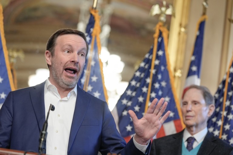 Sen. Chris Murphy, D-Ct., left, speaks as Sen. Ron Wyden, D-Ore., right, listens during a news conference on health insurance premiums on Capitol Hill, Wednesday, Dec. 10, 2025, in Washington. (AP Photo/Mariam Zuhaib)