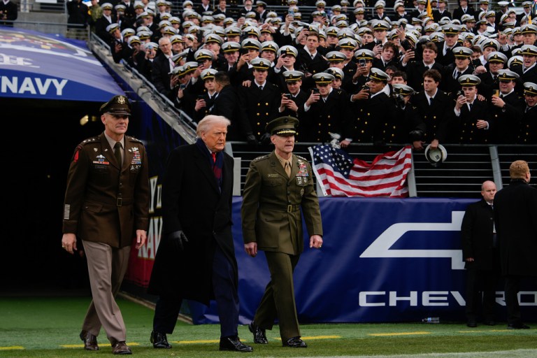 President Donald Trump walks onto the field with Lt. Gen. Steven Gilland, Superintendent of the U.S. Military Academy at West Point