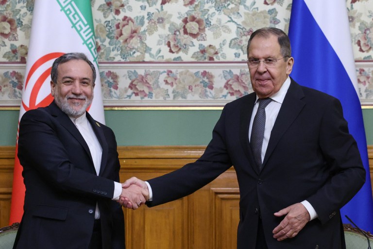 Russian Foreign Minister Sergey Lavrov, right, and Iranian Foreign Minister Abbas Araghchi shake hands