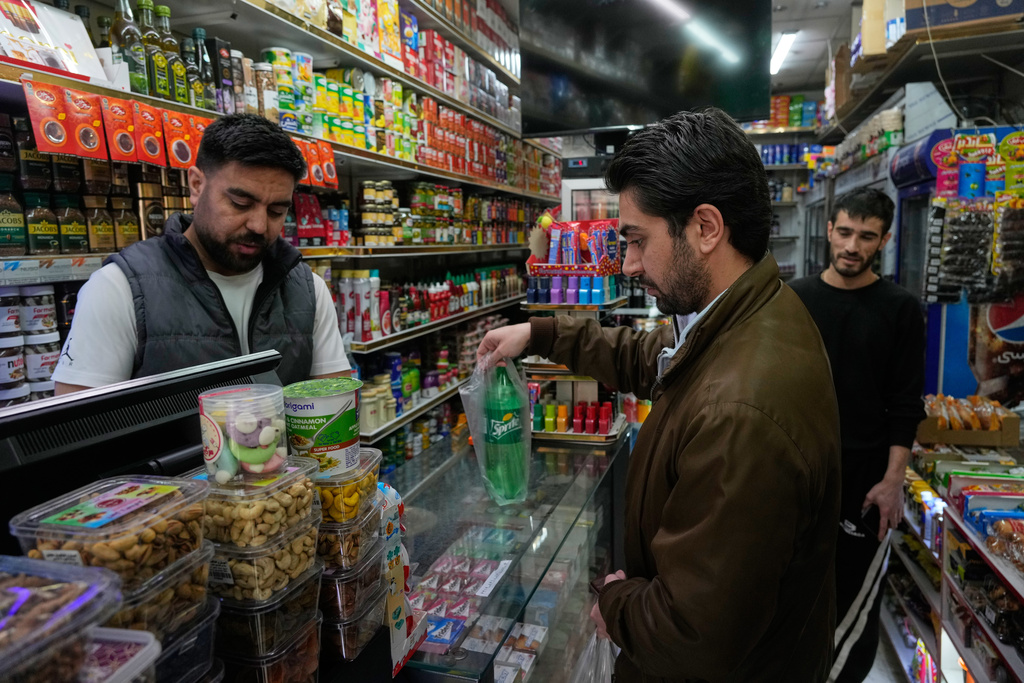 A man shops for soda at a grocery store in northern Tehran, Iran, Tuesday, Jan. 6, 2026.
