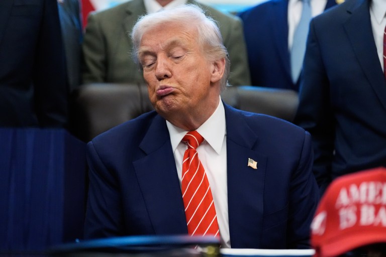President Donald Trump listens before signing a spending bill in the Oval Office.