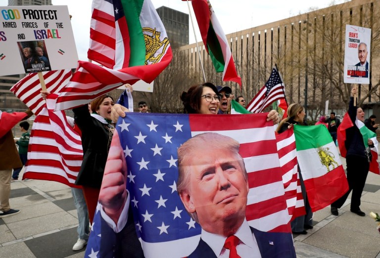 Pegah Jalili, 52, from Frontenac, chants and waves a U.S. flag with Donald Trump's image on it as she celebrates the military action against Iran with a group of Iranians in Kiener Plaza in St. Louis on Saturday, Feb. 28, 2026. Jalili came to United States in 1996 as a student and was granted got political asylum. 