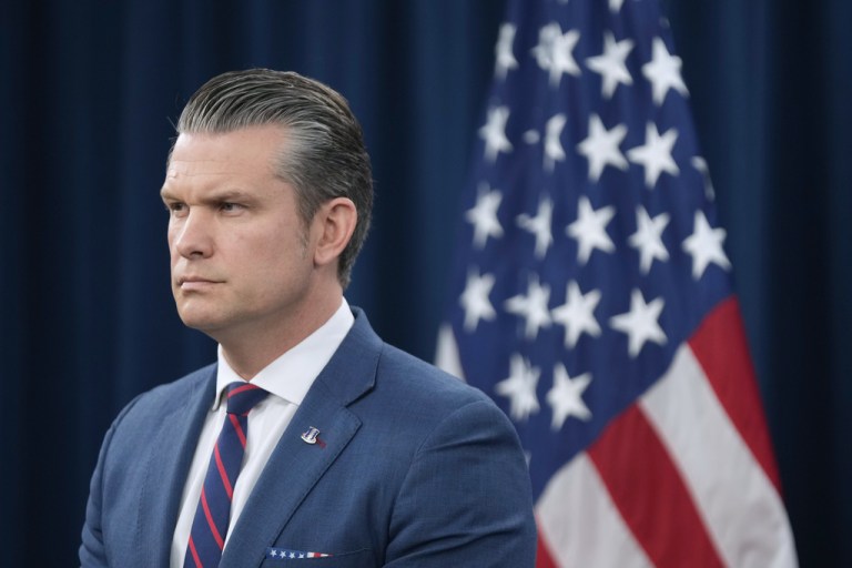 Pete Hegseth listens during a press briefing.