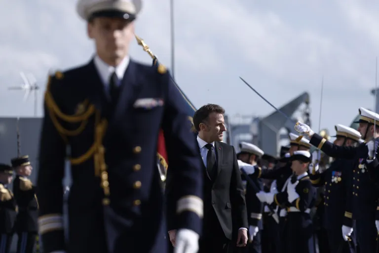French President Emmanuel Macron inspects troops at Ile Longue.
