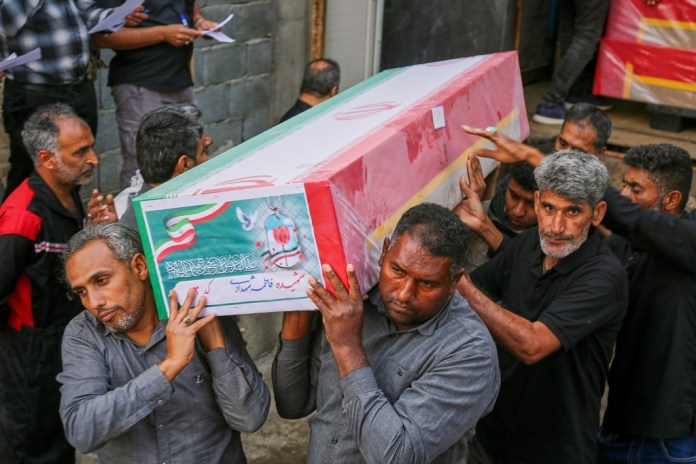 A coffin is carried during the funeral of mostly children killed in a strike Feb. 28 at a girls' elementary school in Minab, Iran,