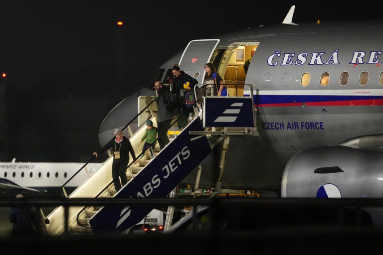 Passengers deplane from an aircraft in Prague