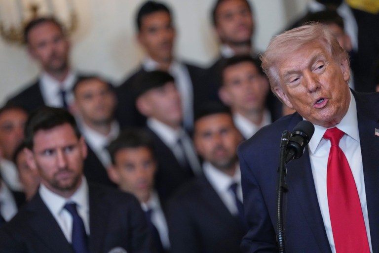 Trump speaking at podium.