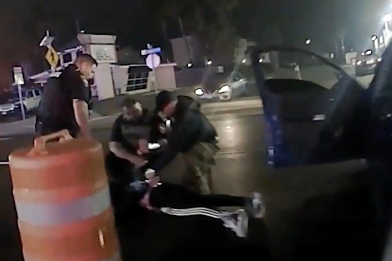 Law enforcement officials surround Ruben Ray Martinez after he was shot.