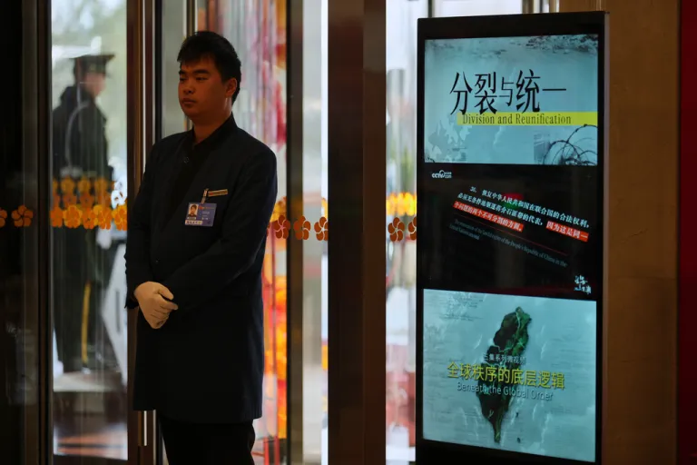 A monitor shows an image of Taiwan and the slogan 
