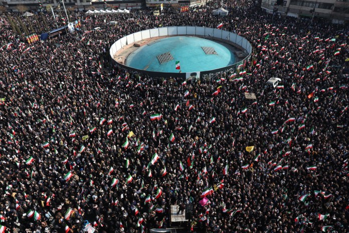 Thousands of Iranians rally in a public square in Tehran