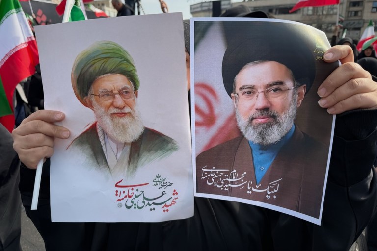 A woman holds posters of Ayatollah Mojtaba Khamenei, right, the successor to his late father, Ayatollah Ali Khamenei, left, as supreme leader, during a rally in Tehran, Iran.