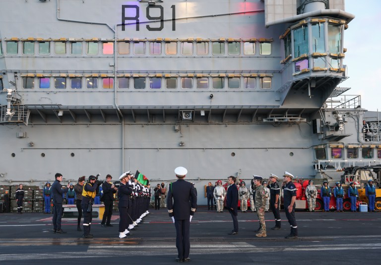 French President Emmanuel Macron, center right, visits the French aircraft carrier Charles de Gaulle