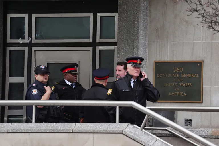 Toronto police officers investigate outside the U.S. consulate