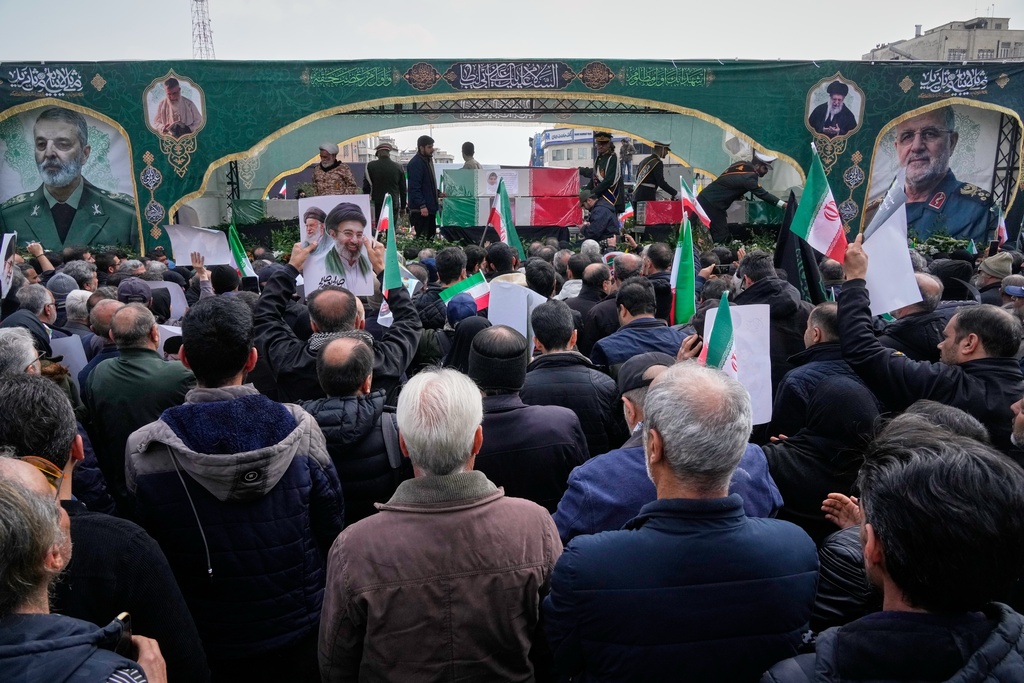 Mourners attend the funeral procession for senior Iranian military officials and some civilians killed during the U.S.-Israel campaign, including Islamic Revolutionary Guard Corps commander Mohammad Pakpour, Defense Minister Aziz Nasirzadeh, Supreme Leader military office chief Mohammad Shirazi, and other officers in Tehran, Iran, Wednesday, March 11, 2026. 