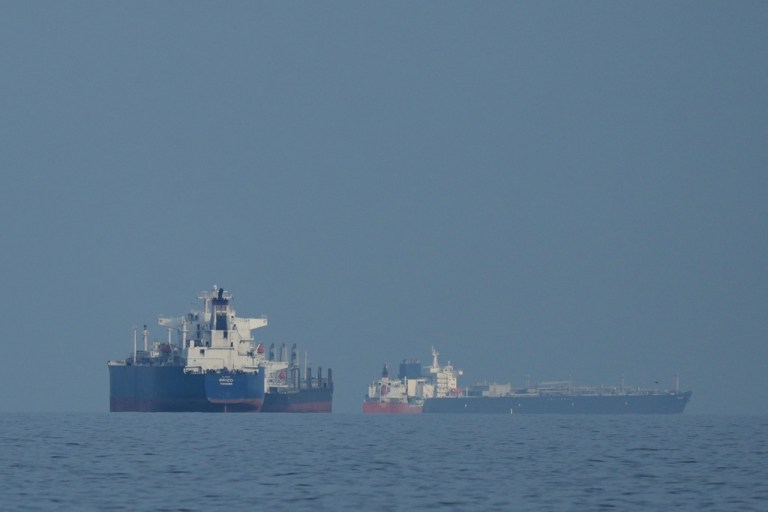 Oil tankers and cargo ships line up in the Strait of Hormuz.