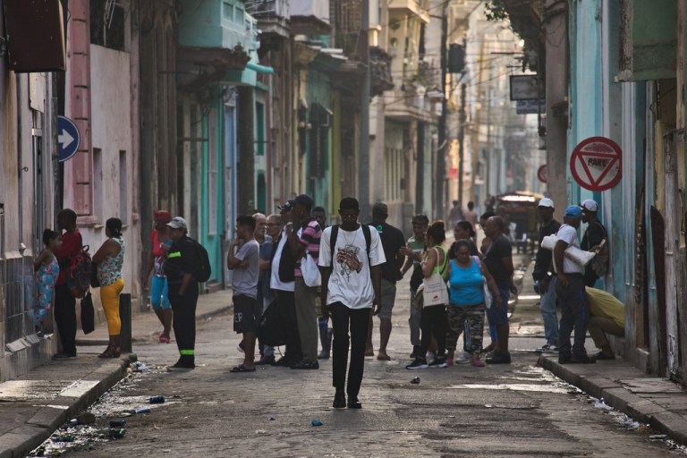 Cubans walking down the street in Havana, Cuba.