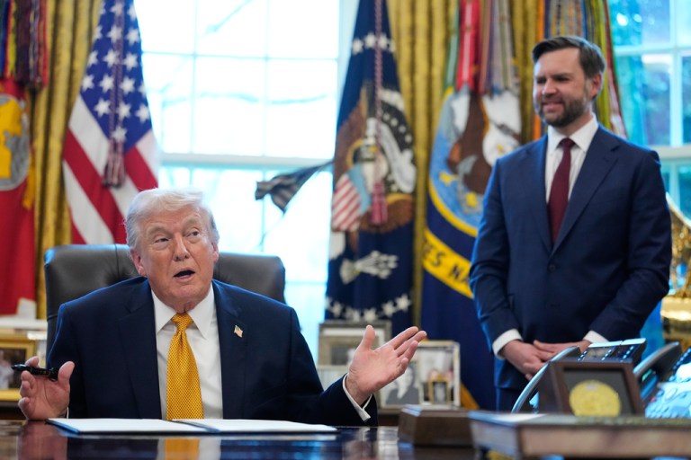 President Donald Trump speaks before signing an executive order regarding a task force on fraud in the Oval Office of the White House, Monday, March 16, 2026, in Washington, as Vice President JD Vance listens.
