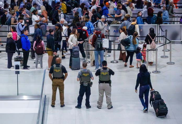 U.S. Immigration and Customs Enforcement (ICE) agents and officers patrol Louis Armstrong International Airport in Kenner, La., Monday, March 23, 2026. (David Grunfeld/The New Orleans Advocate via AP)