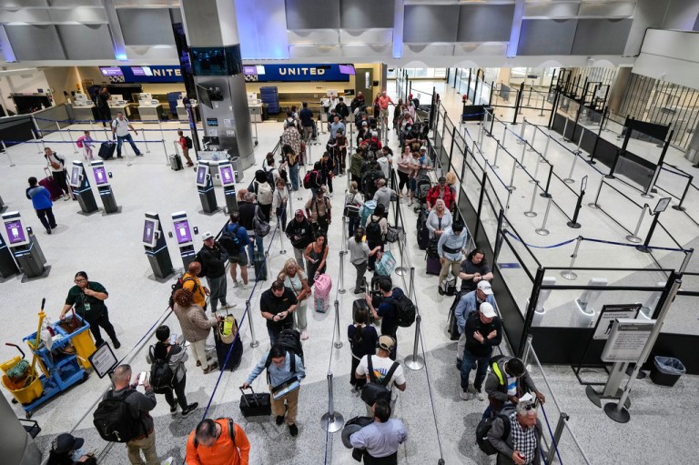 Airline passengers make their way through the security lines, next to a closed screening area, in Terminal C at George Bush Intercontinental Airport, Sunday, March 29, 2026, in Houston. (Brett Coomer/Houston Chronicle via AP)