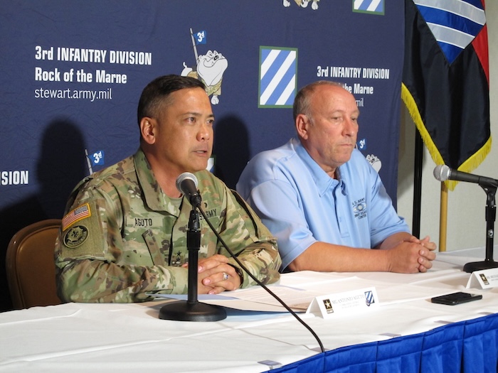 Army Maj. Gen. Antonio Aguto, left, and Army accident investigator Michael Barksdale hold a news conference, Monday, Oct. 21, 2019, at Fort Stewart, Ga., about a training accident that killed three soldiers and injured three others. Aguto said the soldiers' armored vehicle rolled off a bridge and landed upside down in a stream during a training exercise being conducted before dawn the day before. The cause of the fatal crash is being investigated. (AP Photo/Russ Bynum)