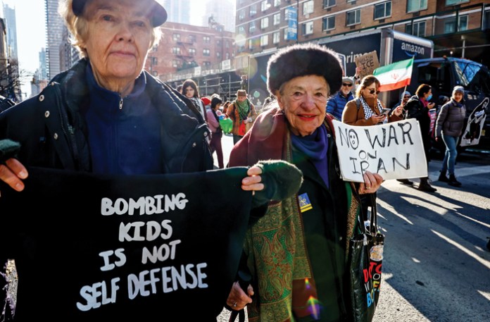 A protest in New York City, Feb. 28, 2026; at right, a demonstrator in Seattle, March 18, 2026. (Kena Betancur/AP)