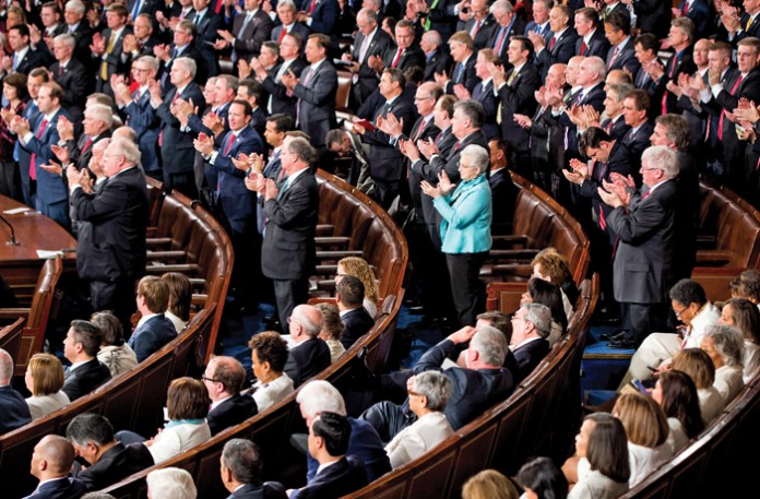 Democrats stay seated as Republicans give a standing ovation during President Donald Trump’s address to a joint session of Congress, Feb. 28, 2017. (Bill Clark / CQ Roll Call / Getty)