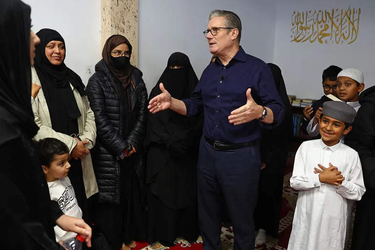 Britain's Prime Minister Keir Starmer reacts during a visit to Peacehaven Mosque near Brighton in southern England, on October 23, 2025.