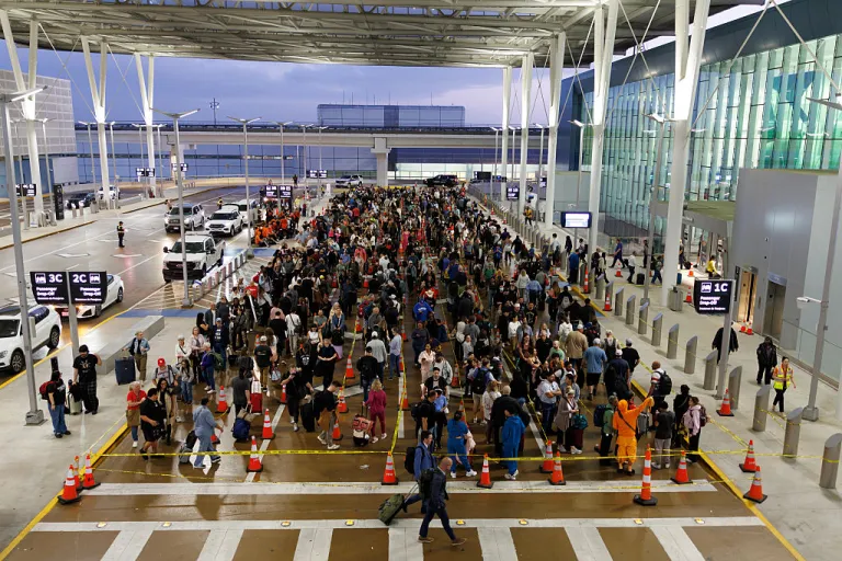 Travelers wait in line at a Transportation Security Administration (TSA) checkpoint at George Bush Intercontinental Airport (IAH) in Houston, Texas, US, on Thursday, March 26, 2026. The Transportation Security Administration warned that airport security is under severe strain as a weeks-long Department of Homeland Security funding shutdown drives staffing shortages, long wait times and mounting disruptions across the US. Photographer: Mark Felix/Bloomberg via Getty Images