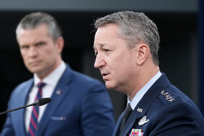 Defense Secretary Pete Hegseth listens to Chairman of the Joint Chiefs of Staff Gen. Dan Caine during a press briefing at the Pentagon, Monday, March 2, 2026, in Washington. (AP Photo/Mark Schiefelbein)