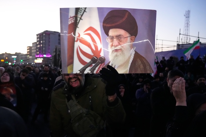 Government supporters mourn in a gathering after state TV officially announced the death of Iranian Supreme Leader Ayatollah Ali Khamenei, shown in the poster, in Tehran, Iran, Sunday, March 1, 2026. (AP Photo/Vahid Salemi)