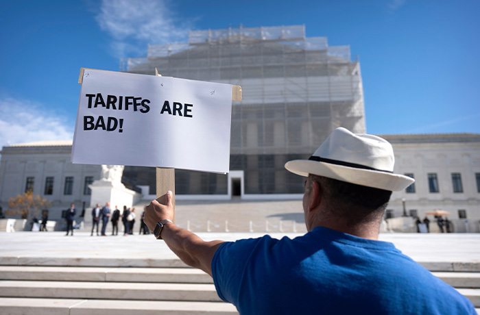 A demonstrator protests outside the Supreme Court in Washington on Nov. 5, 2025. (Mark Schiefelbein/AP)