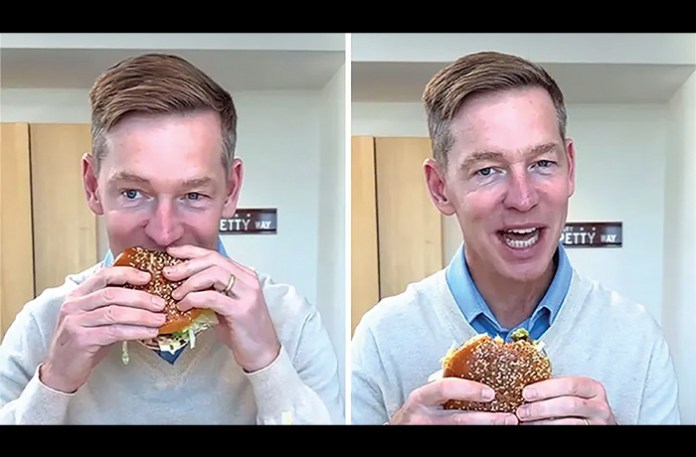 McDonald’s CEO Chris Kempczinski takes a bite out of the new Big Arch sandwich in a now-viral clip. (Courtesy of McDonald’s)