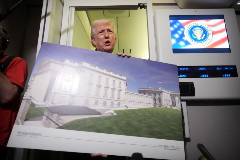 Trump with a concept board for his ballroom.