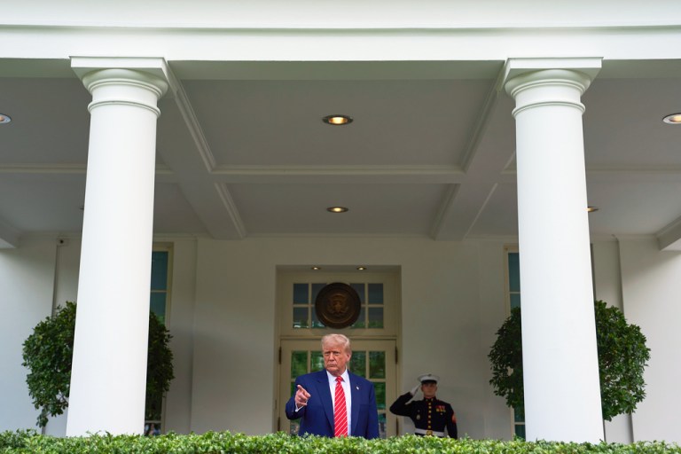 President Donald Trump speaks to reporters outside the West Wing of the White House.