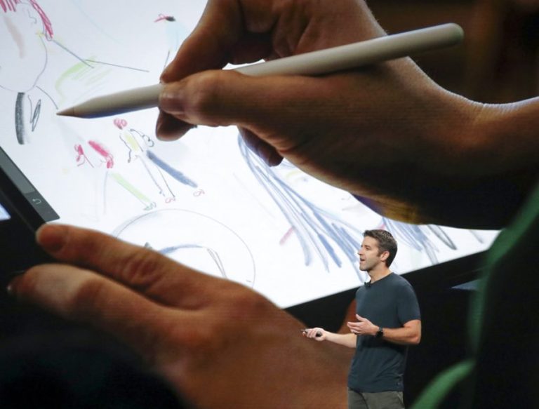 John Ternus in front of screen showing iPad and Apple Pencil