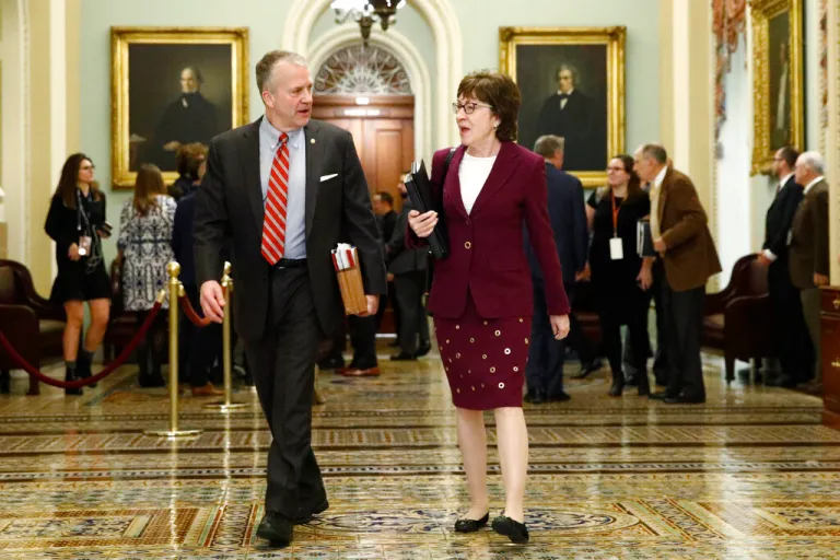 Sen. Susan Collins, R-Maine, right, walks with Sen. Dan Sullivan, R-Alaska, walk to the Senate chamber at the Capitol, Wednesday, Jan. 22, 2020