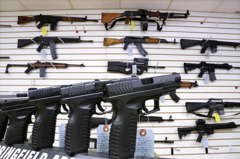 Assault weapons and handguns are seen for sale.