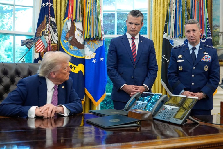President Donald Trump looks to Defense Secretary Pete Hegseth and Chairman of the Joint Chiefs of Staff Gen. Dan Caine as he speaks in the Oval Office
