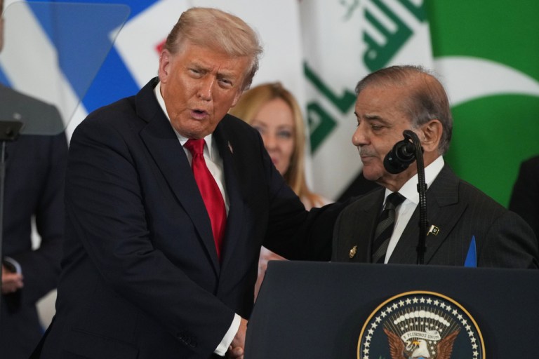 President Donald Trump shakes hands with Pakistani Prime Minister Shehbaz Sharif.