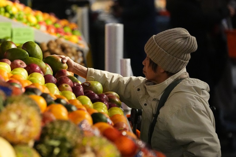 A customer shops at the Reading Terminal Market in Philadelphia, Wednesday, Dec. 10, 2025.