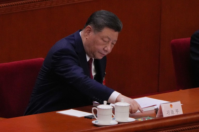 Chinese President Xi Jinping, presses a button to vote