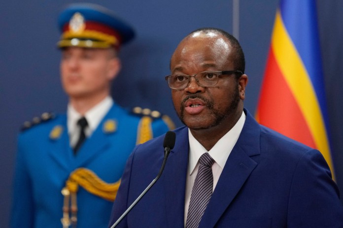 King Mswati III of Eswatini speaks at a podium