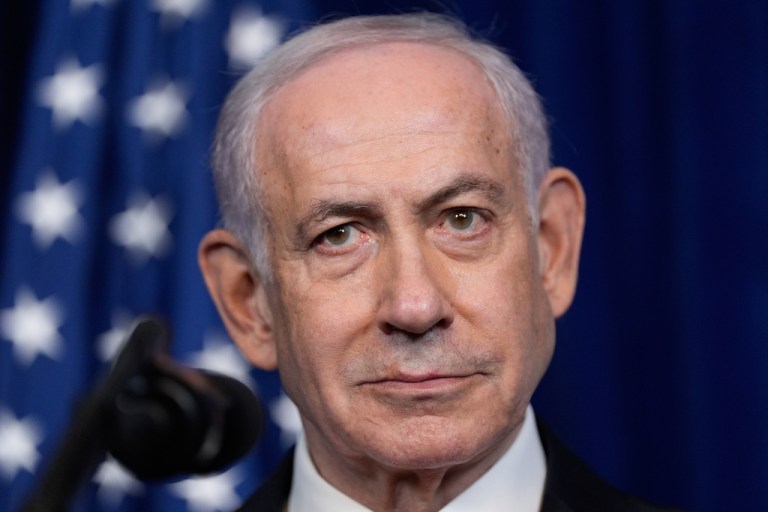 Israeli Prime Minister Benjamin Netanyahu listens during a December 2025 news conference with President Donald Trump.