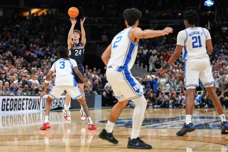 Connecticut guard Braylon Mullins scores the winning basket during the second half against Duke in the Elite Eight of the NCAA basketball tournament