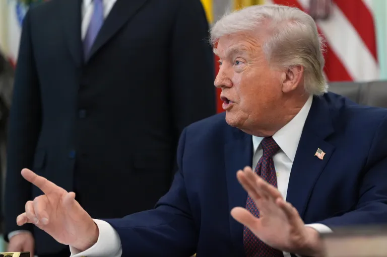 Donald Trump speaks to reporters after signing an executive order.