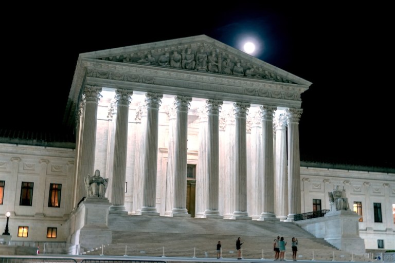 The U.S. Supreme Court is seen as the moon rises Tuesday, March 31, 2026, in Washington. (AP Photo/Jose Luis Magana)