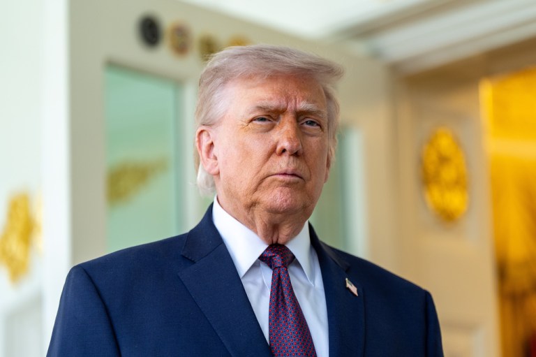 President Donald Trump speaks with reporters outside the Oval Office.