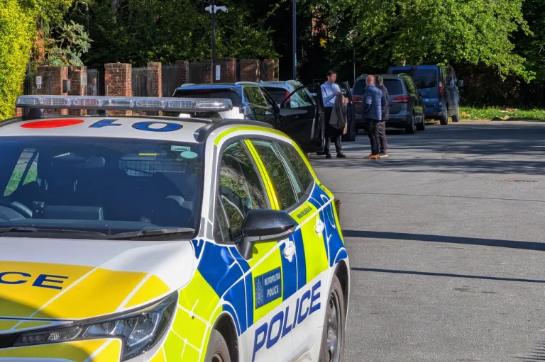 A police car is parked outside Kenton United Synagogue