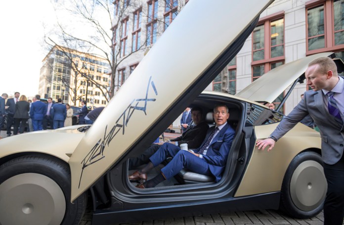 Transportation Secretary Sean Duffy sits in a Tesla Cybercab autonomous vehicle during the National AV Safety Forum at the U.S. Department of Transportation on March 10 in Washington. (Rod Lamkey, Jr./AP)
